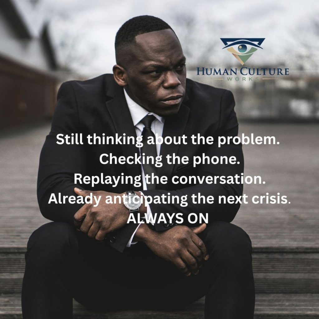 Still thinking about the problem, checking the phone, replaying the conversation, always on. Text over a leader sitting with a tense expression